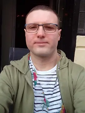 Young man with glasses looking at the camera