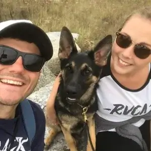 Young man and woman in sunglasses with their dog