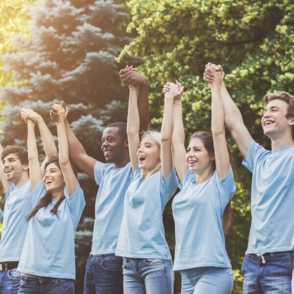 Fundraising events for Brain Tumour Support. Picture shows a group of men and women celebrating a win with hands in the air.