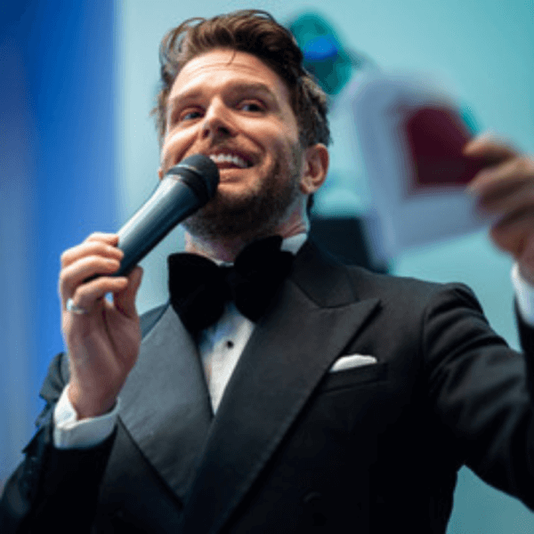 Joel Dommett speaking at The Emerald Ball charity event for Brain Tumour Support