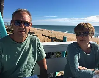 Richard and Sue Warren sitting together on a sunny day.