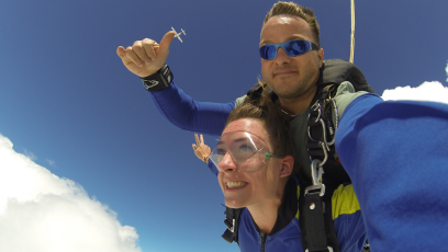 Fundraising events for Brain Tumour Support. Two skydivers against a blue sky with thumbs up