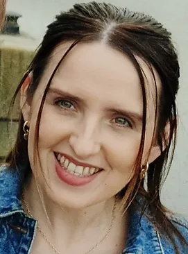 Profile picture of young woman with dark hair smiling at the camera