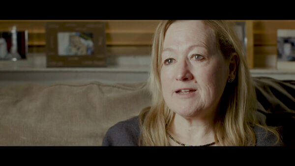 Woman facing the video and telling her story