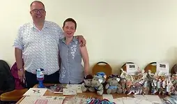 Dave Stubbs standing in front of stall selling Brain Tumour Support charity merchandise