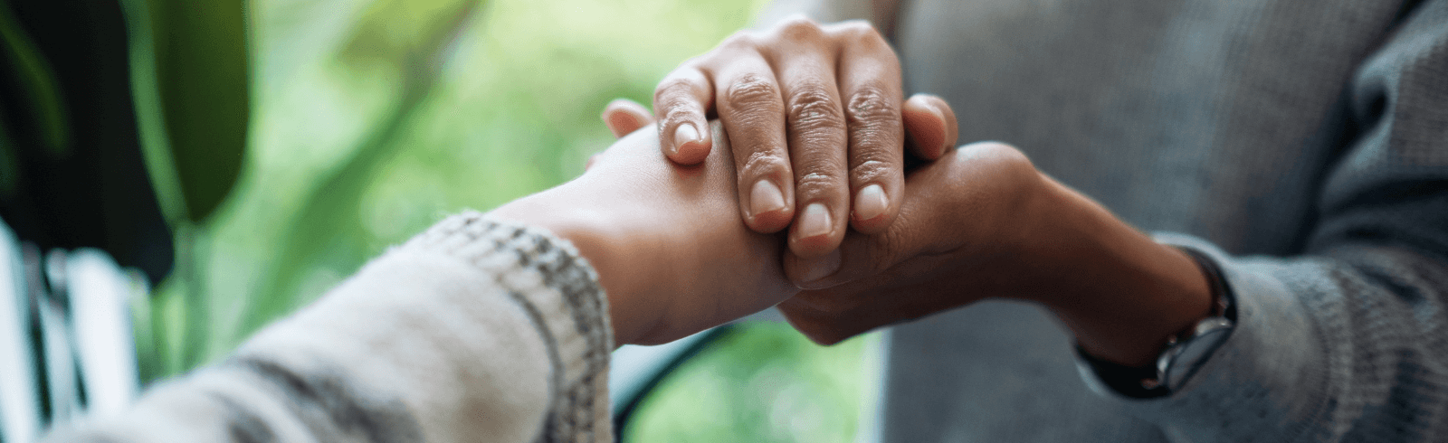 Person hold the hand of another. Close up