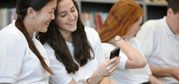 Schoolgirls chatting in classroom