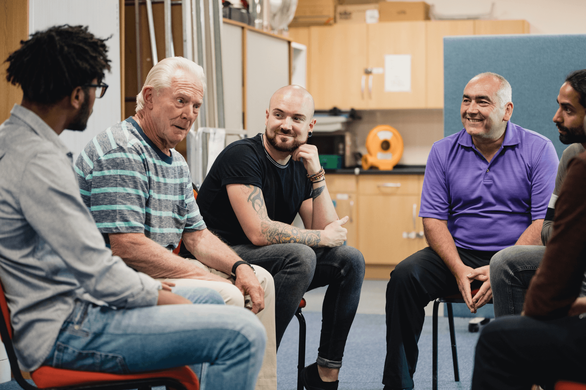 Men sitting and talking in a friendly group