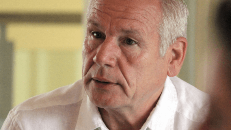 Grey-haired man listening attentively