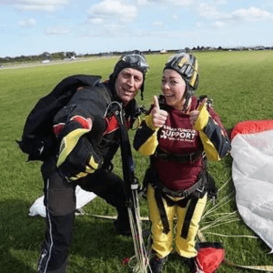 Fundraising with Brain Tumour Support. Man and woman in skydiving outfits after a charity skydive event