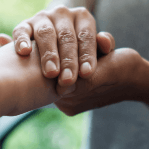 Person holding the hand of another. Close up