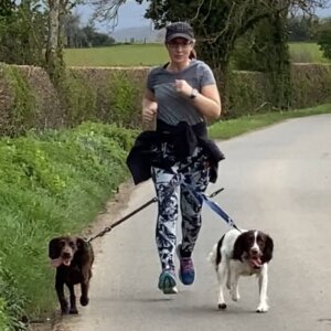 Sarah running with her two dogs