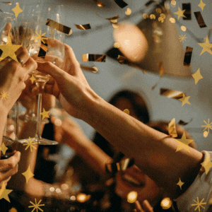 Hands raised in the air holding champagne glasses with gold confetti floating down