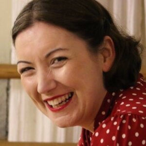 Simone wearing red and white spotted top, smiling broadly