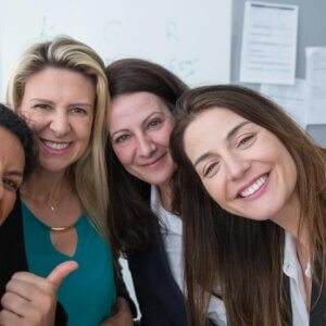 Female work colleagues smiling at the camera